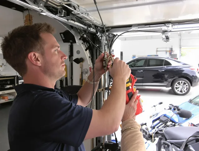 Gastonia Garage Door Repair safety certified technician performing cable replacement in Gastonia